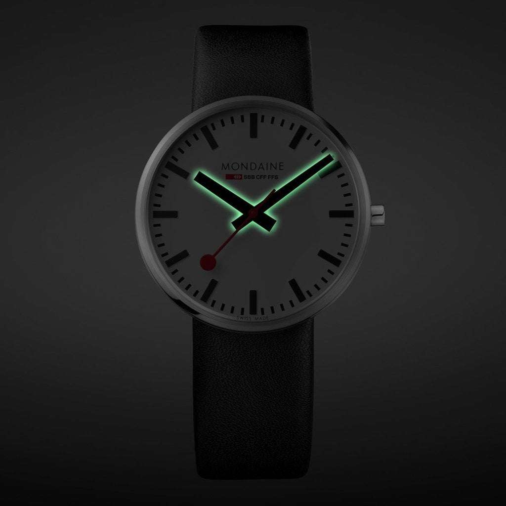 Men's quartz watch with dark dial and green luminous hour markers, black leather strap