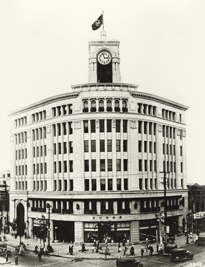 Historic black and white photo of the Hattori Clock Tower building in Ginza, Tokyo