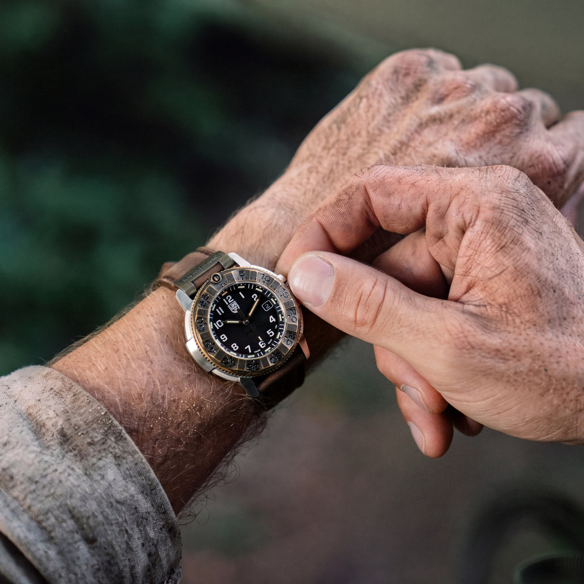 Close-up of the Luminox Adventure Watch XL.1301.LG on wrist highlighting its textured bronze bezel and leather strap.
