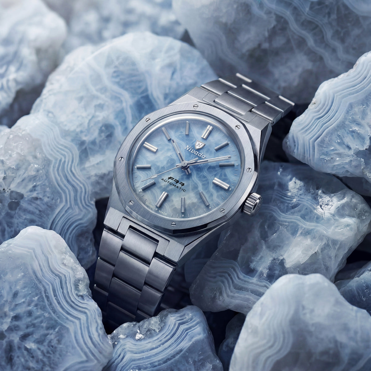 Nivada Grenchen F77 MK2 68061A77 angled view featuring ice agate dial set against raw agate minerals