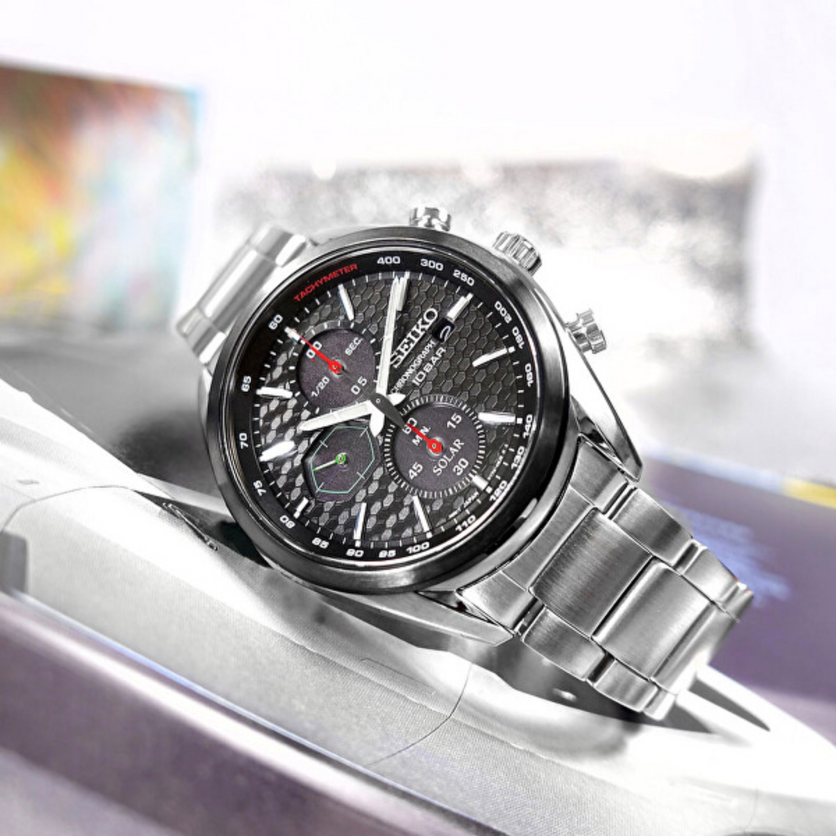 Seiko solar chronograph watch on cushion, black dial with subdials, steel bracelet