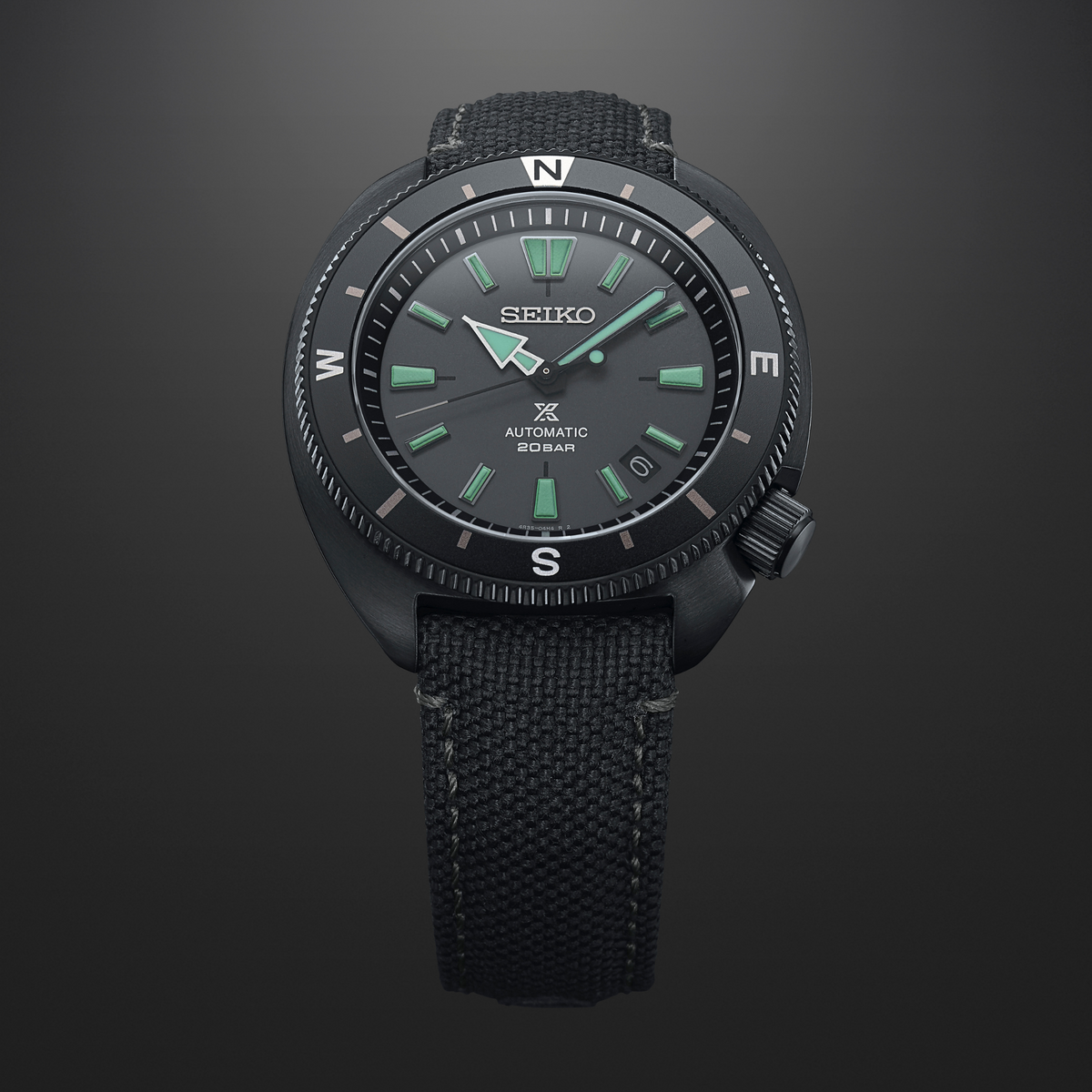 Seiko Prospex diver-style automatic watch with textured black fabric strap and green-accent dial.