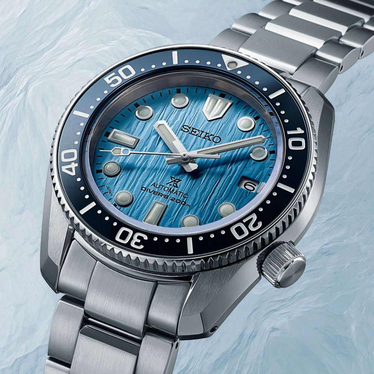 Men's diver watch with blue textured dial, black bezel, and stainless bracelet