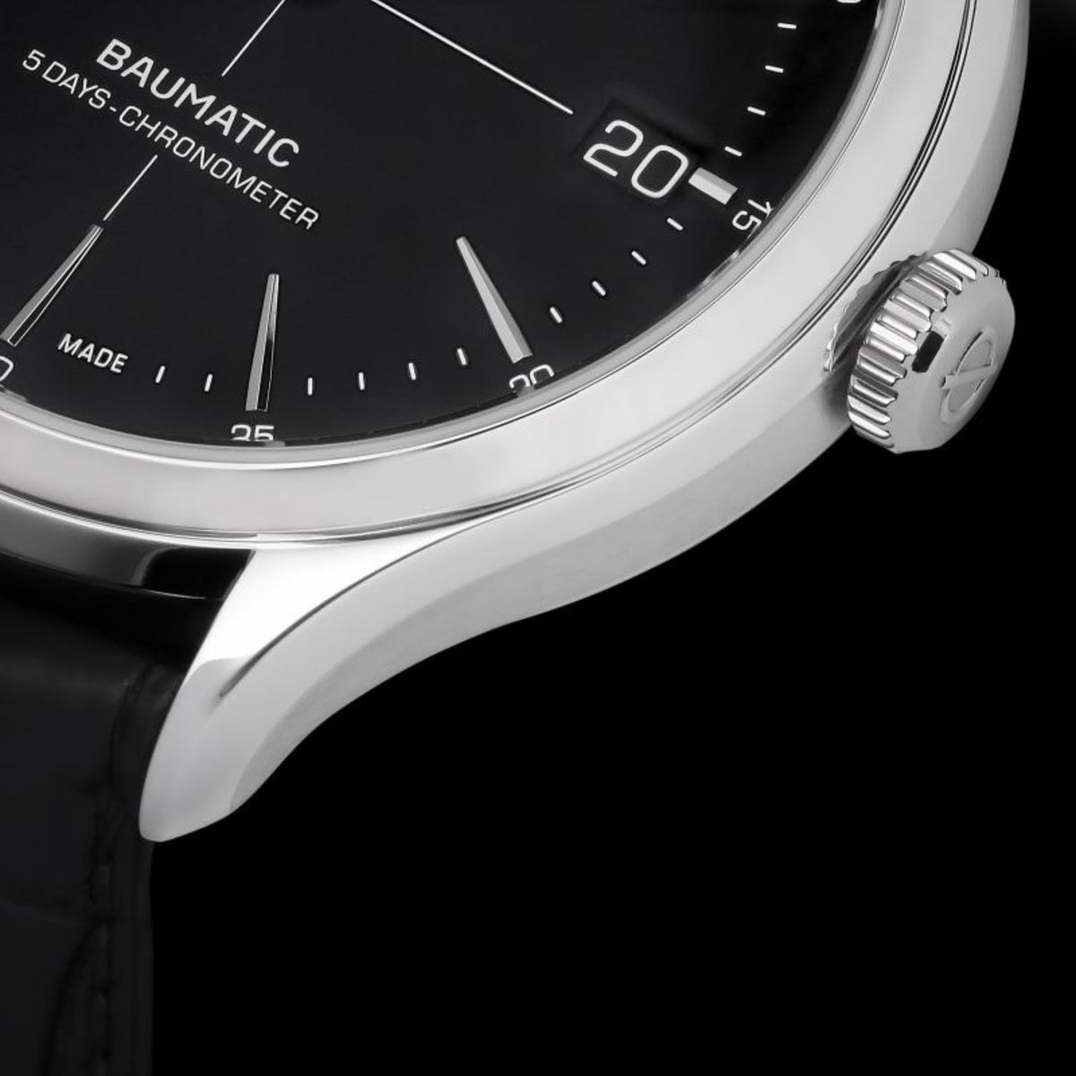 Men's automatic wristwatch close-up of bezel and crown with black dial markers.