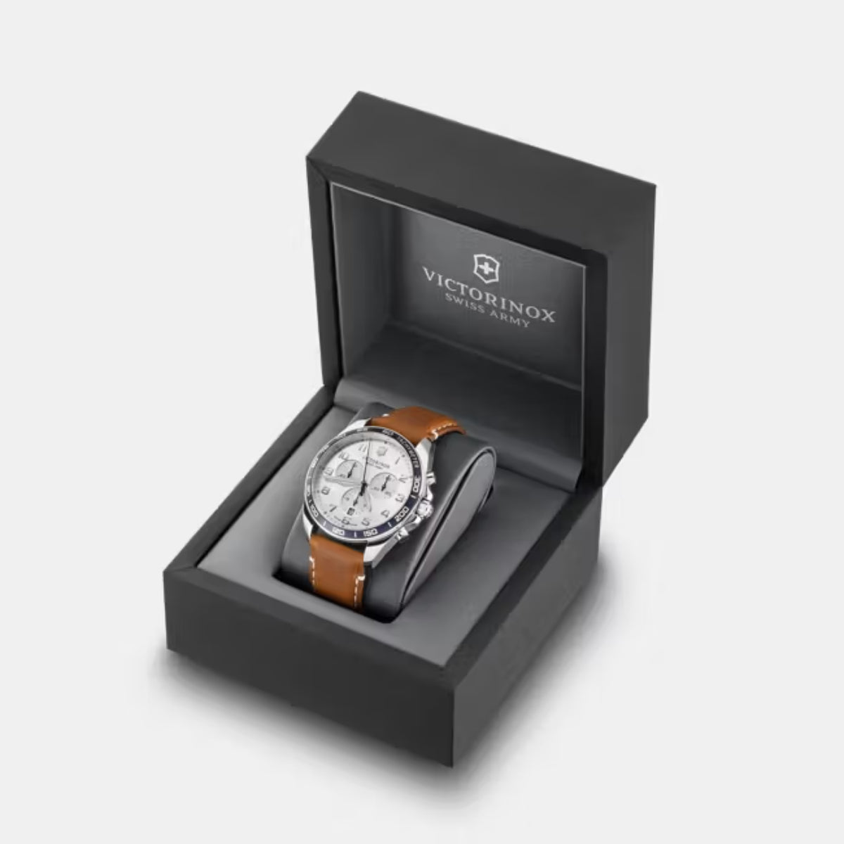 Chronograph watch displayed in open black gift box with brown leather strap