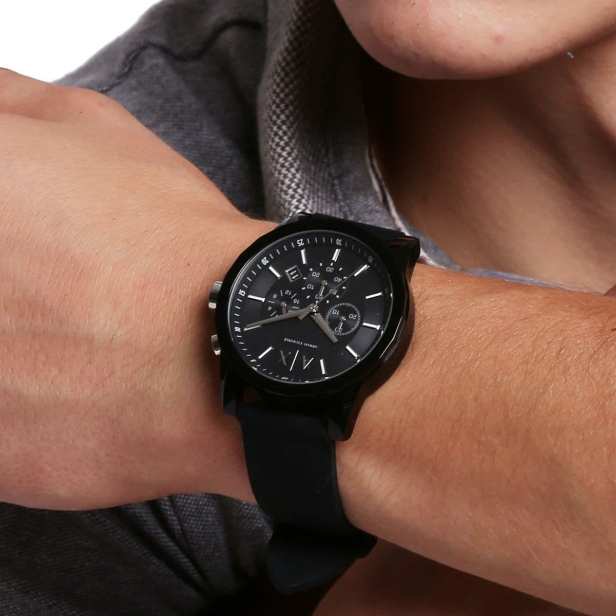 Men's Armani Exchange chronograph watch worn on wrist, black dial and black rubber strap