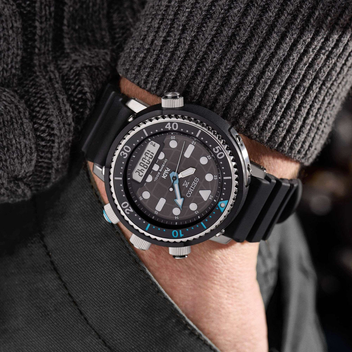 Seiko Prospex Solar SNJ035P1F wristwatch with a detailed face on a person's wrist, wearing a dark sweater.