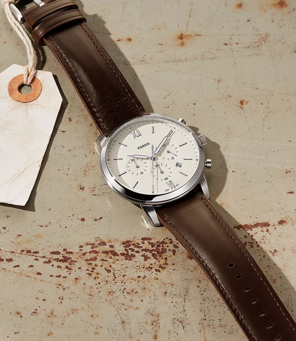 Fossil Neutra mens brown leather watch showing cream chronograph dial, silver-tone case, and classic date display window