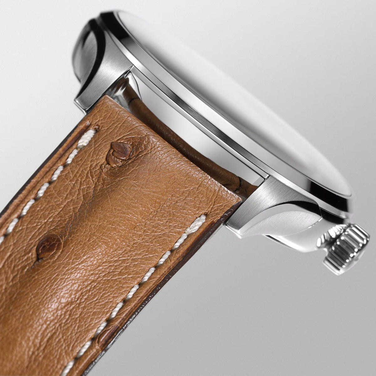 Men's automatic watch side view with tan leather strap and stainless steel crown