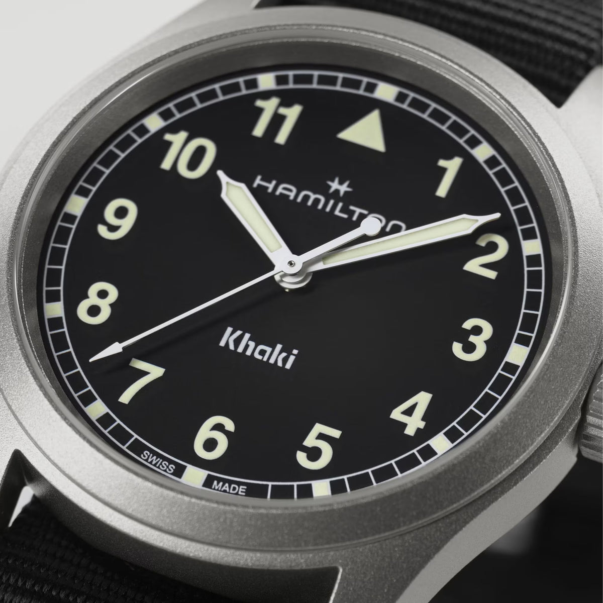 Hamilton Khaki Field H69401430 38mm mens watch close-up detail showcasing black dial with luminous Arabic numerals and hands