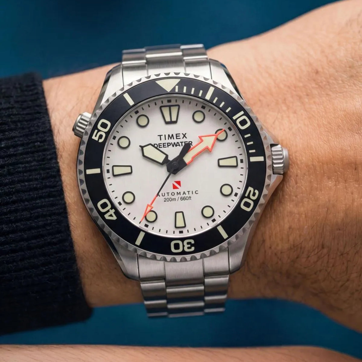 Timex Deepwater TW3A01600 wrist view showing white dial automatic watch styled on a person wearing a steel bracelet