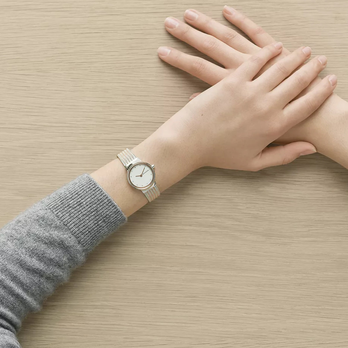 Overhead View of Skagen Freja Lille SKW2699 Watch Worn on Wrist Resting on Wooden Surface