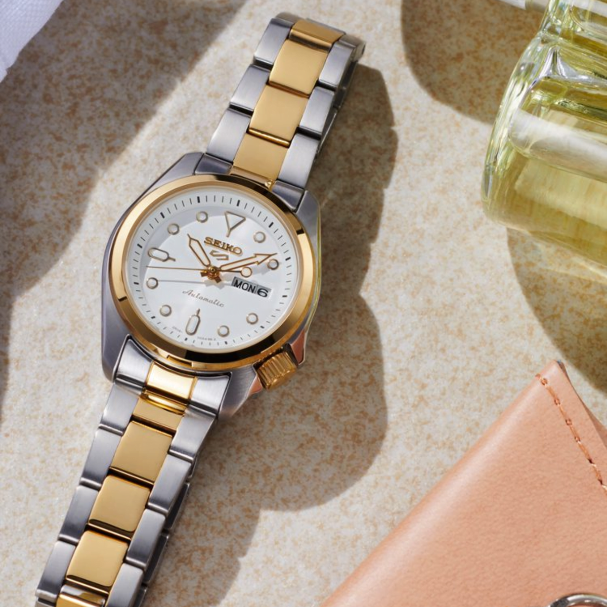 Two-tone stainless steel ladies automatic watch with white dial and gold bezel details