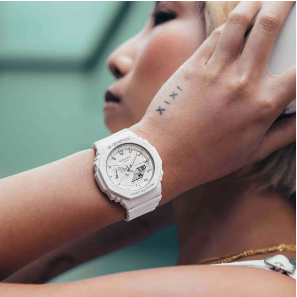 Casio G-Shock GMA-S2100-7AER lifestyle shot featuring a white dial display watch worn on the wrist