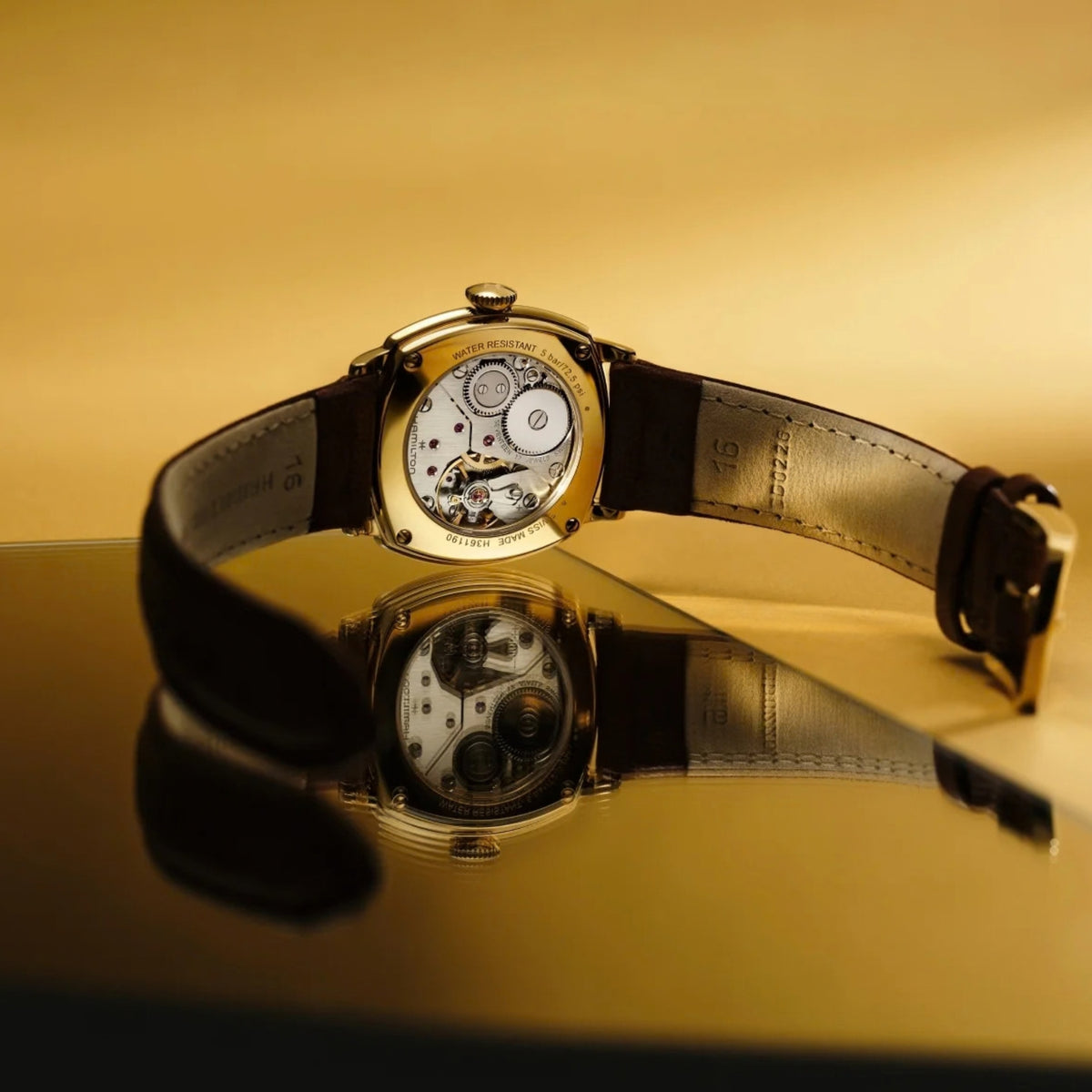 Hamilton American Classic Cushion Mechanical H36119520 showing beige dial watch on reflective surface