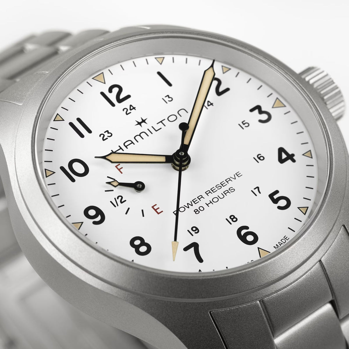 Hamilton Khaki Field H69509110 40mm watch close-up detail displaying white dial texture, luminous hands, and power reserve sub-dial
