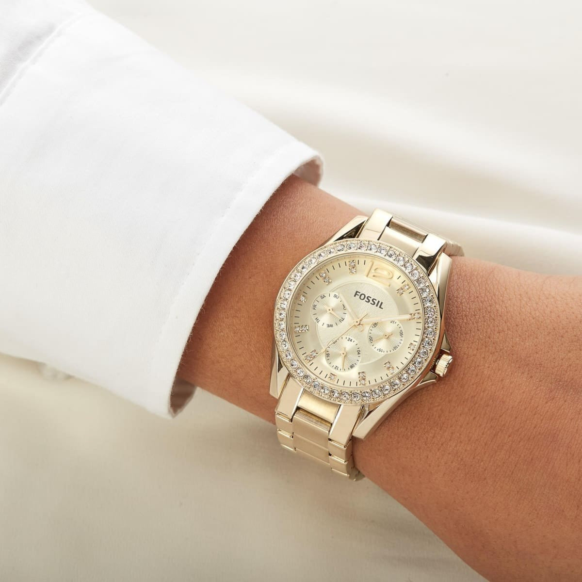 Angled wrist shot of the Fossil Riley ES3203 chronograph timepiece highlighting the stone-encrusted top ring and champagne dial