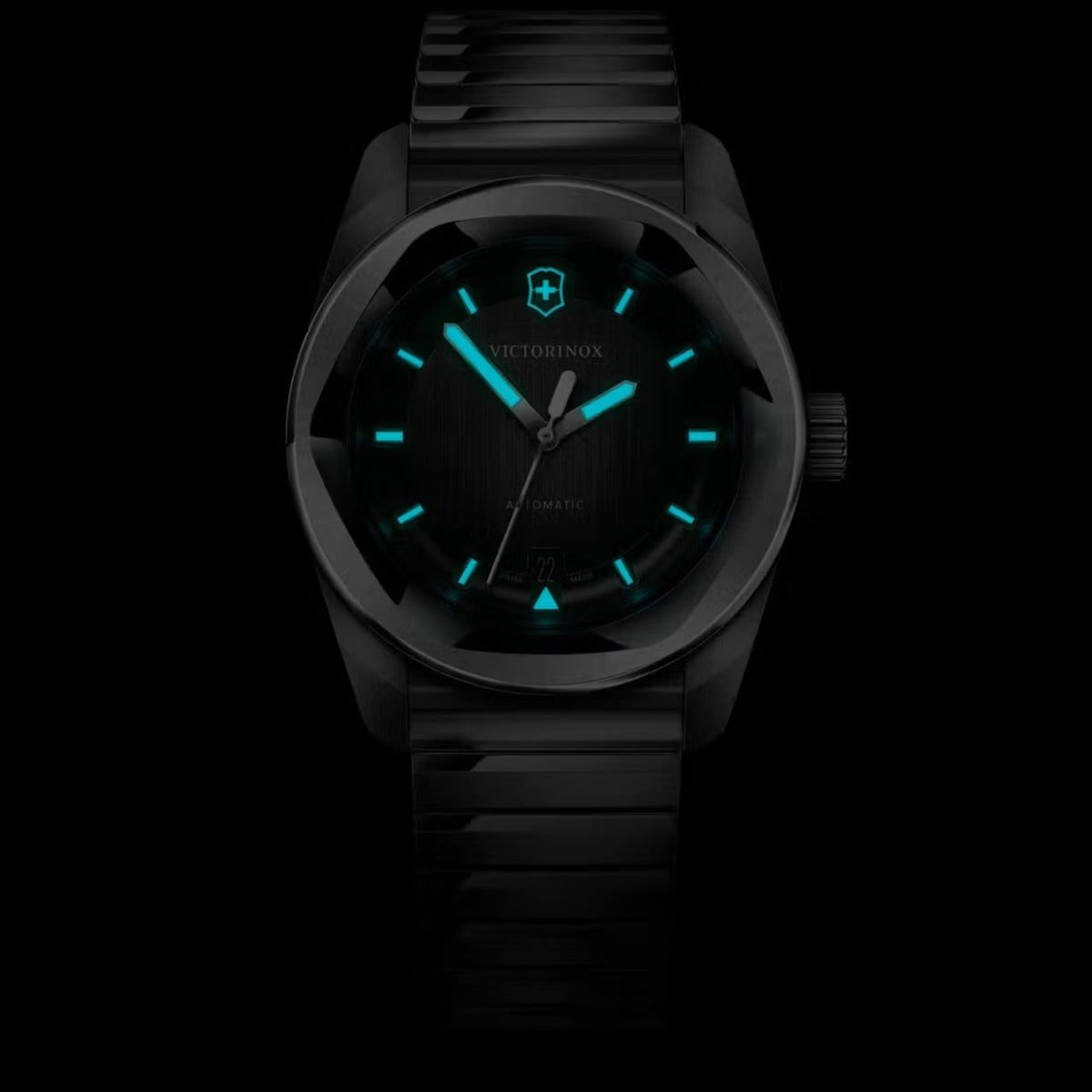 Victorinox automatic watch in the dark, with its hands, markers, and logo glowing
