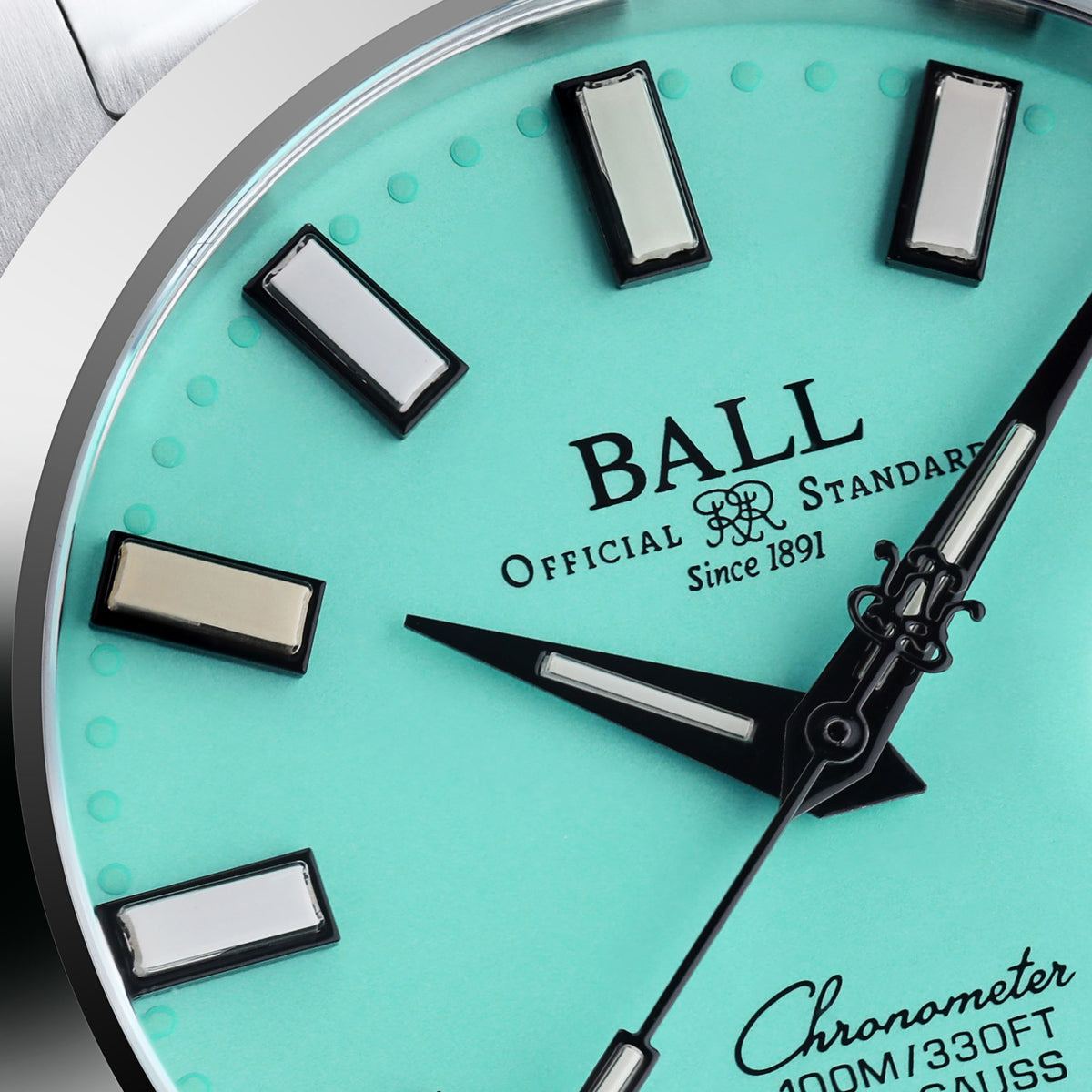 Turquoise dial watch face with BALL logo, baton markers, black hands, date subdial text
