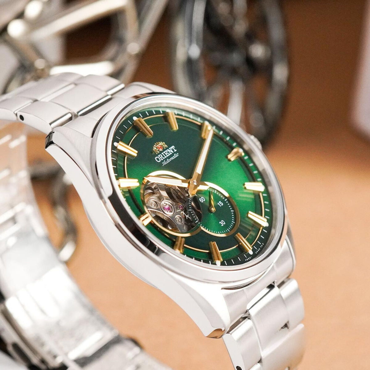 Angled view showcasing the polished steel case and reflective green dial of the Orient Stretto RA-AR0008E30B