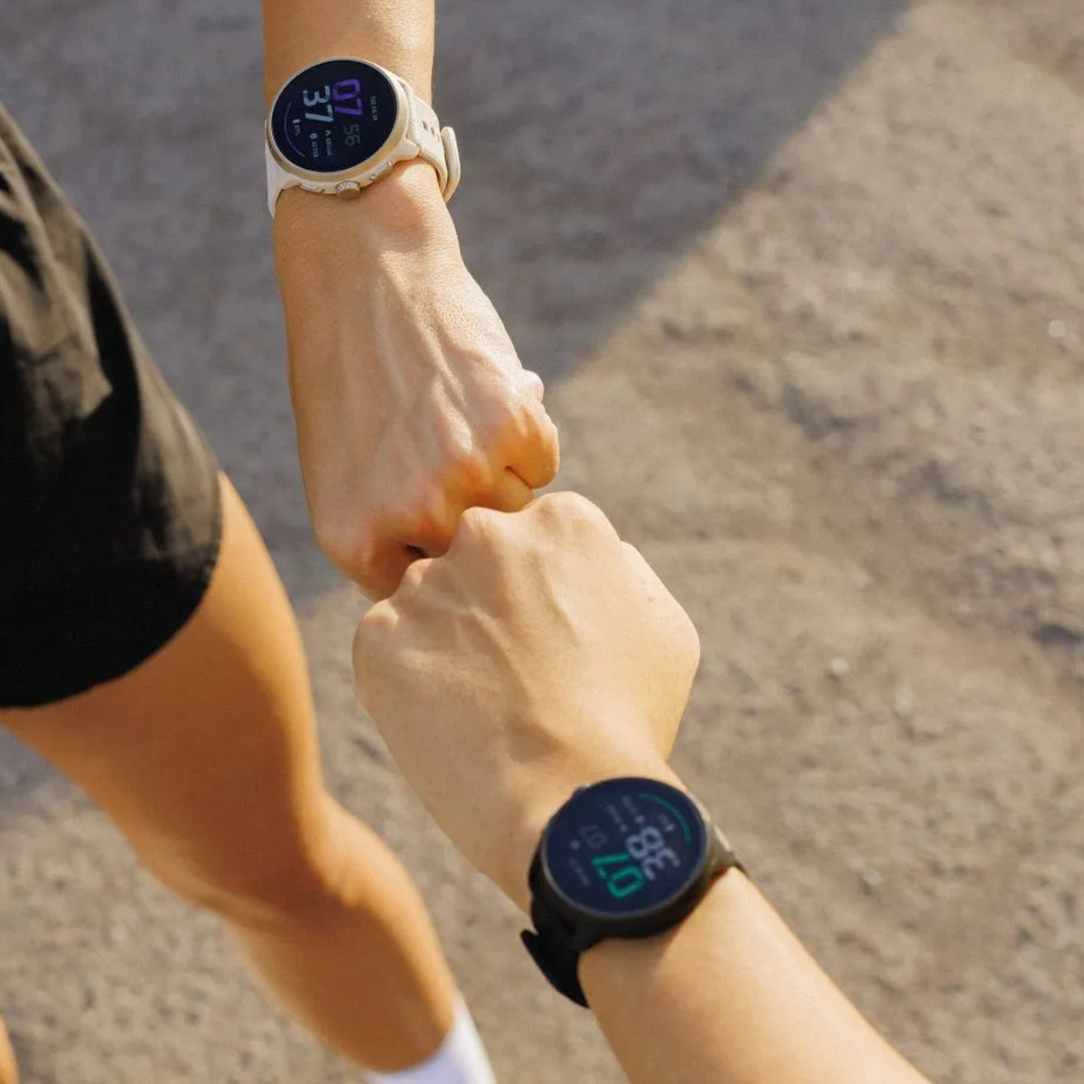 Suunto Run SS051639000 action shot on runner's wrist alongside workout partner outdoors