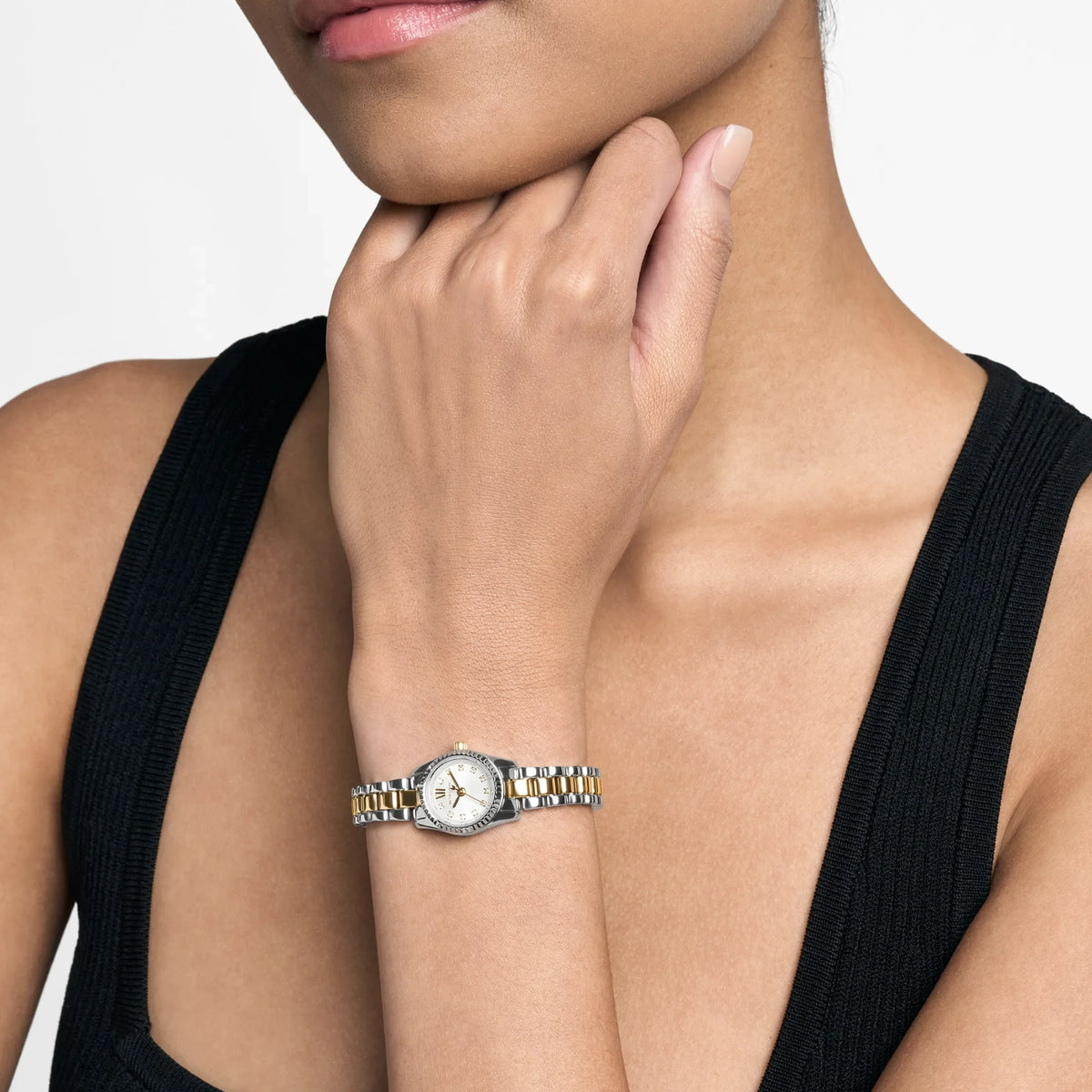 Two-tone steel quartz watch with silver dial, worn on wrist