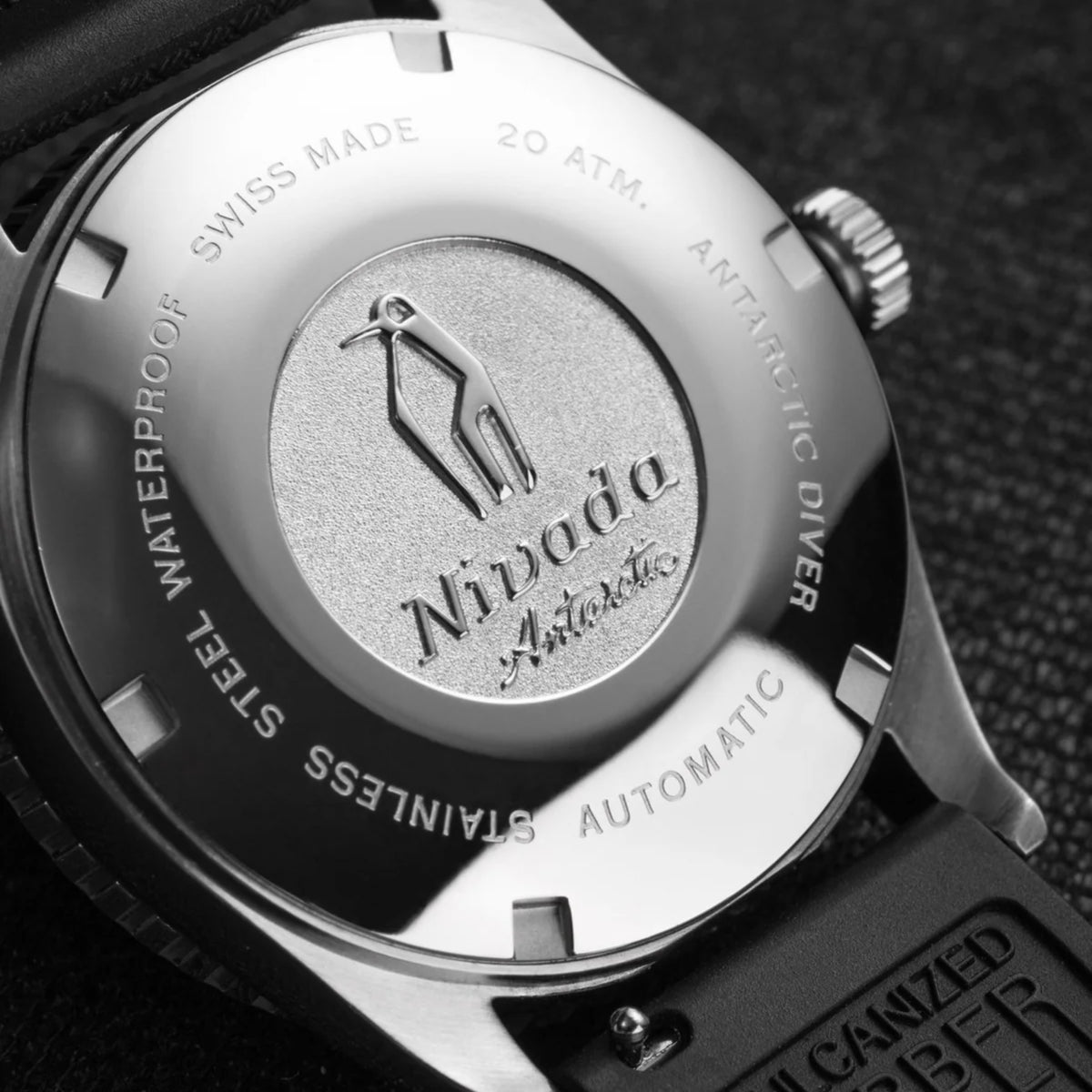 Stainless steel caseback with water-resistance text and Nivada logo on a diver watch