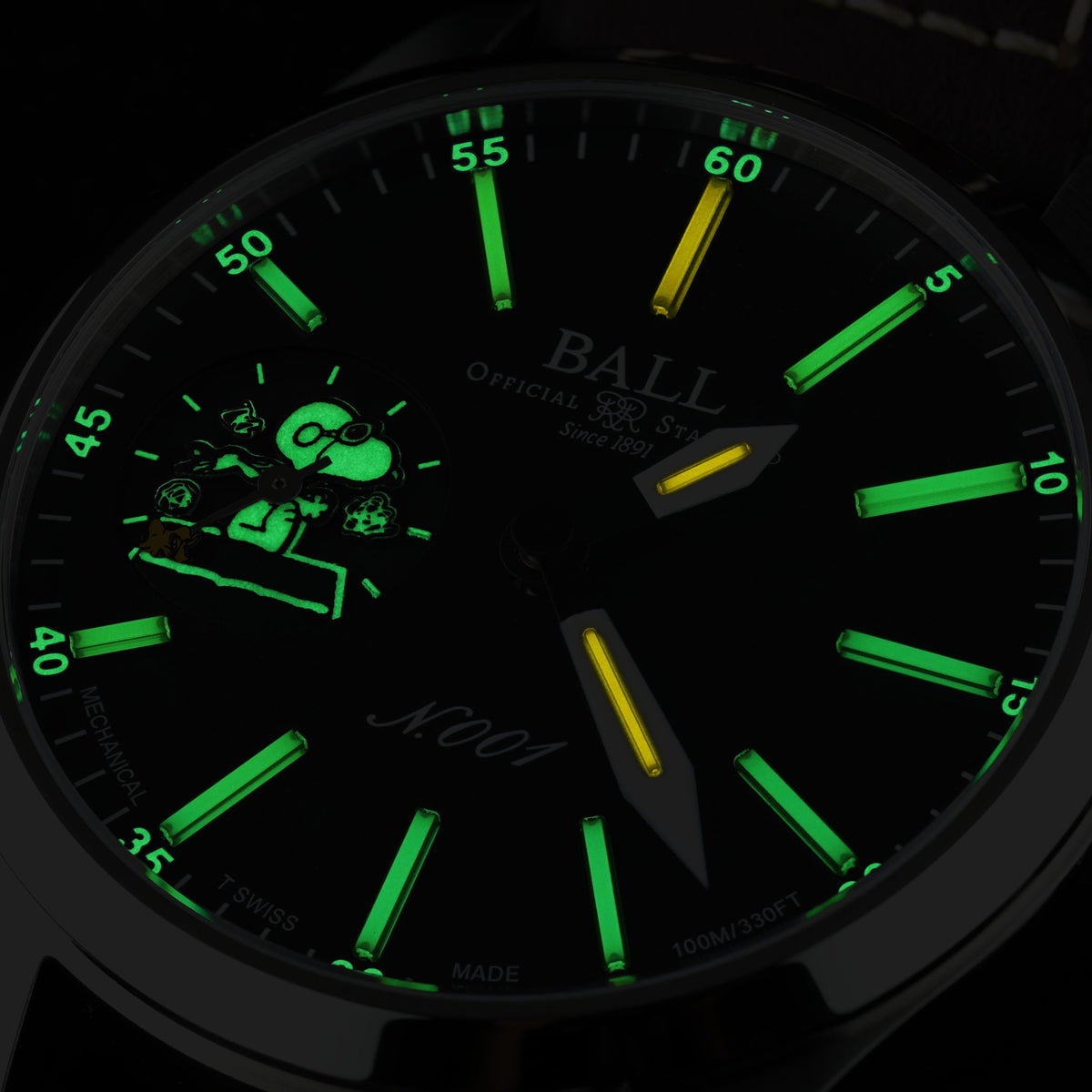 Men's wristwatch dial lit with green lume markers and hands on dark background.