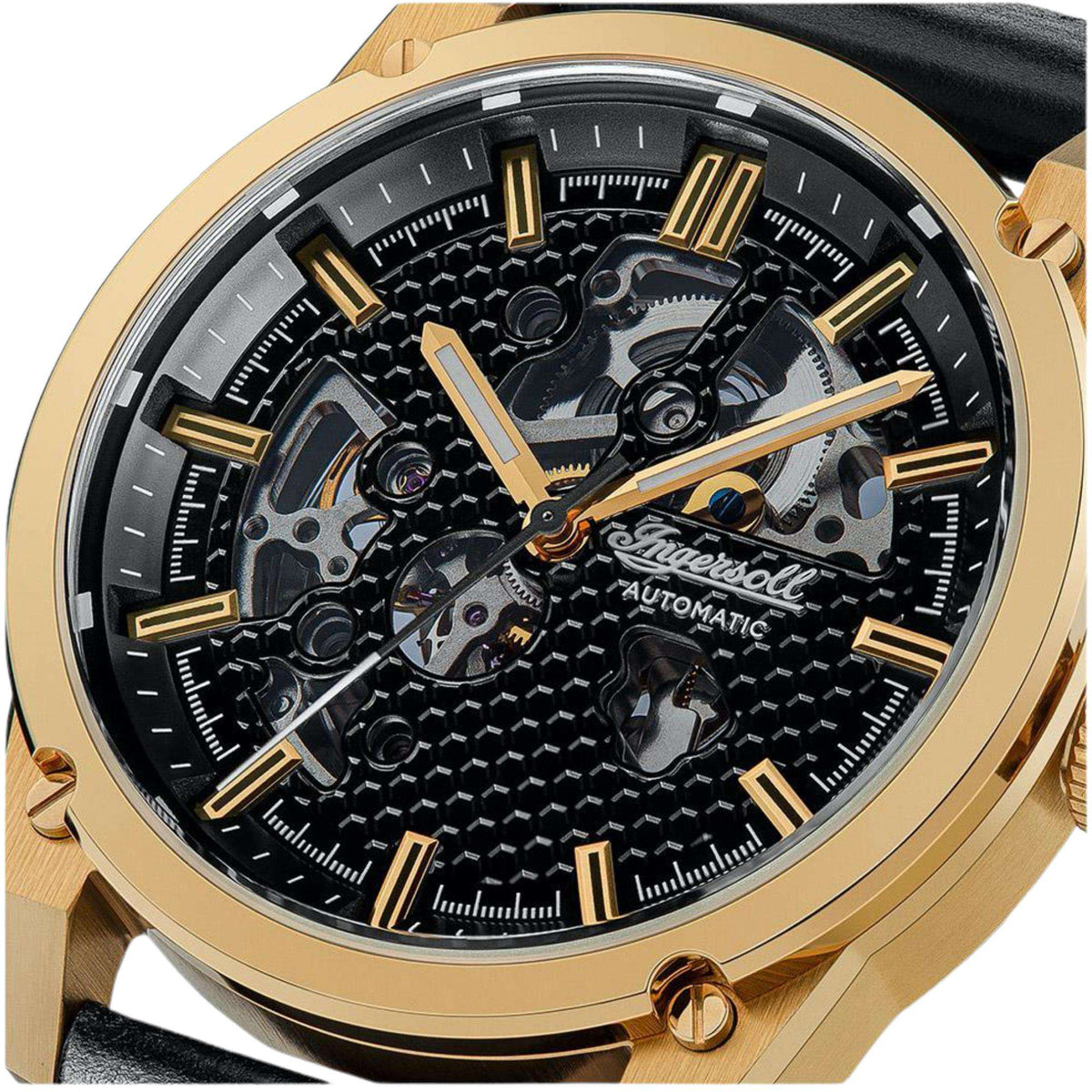 Close-up of black skeleton dial with gold hands, markers, and automatic movement