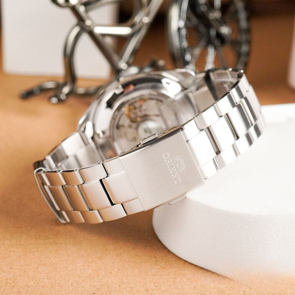 Back view showing the brushed stainless steel folding clasp engraved with the brand logo on the Orient Stretto RA-AR0008E30B