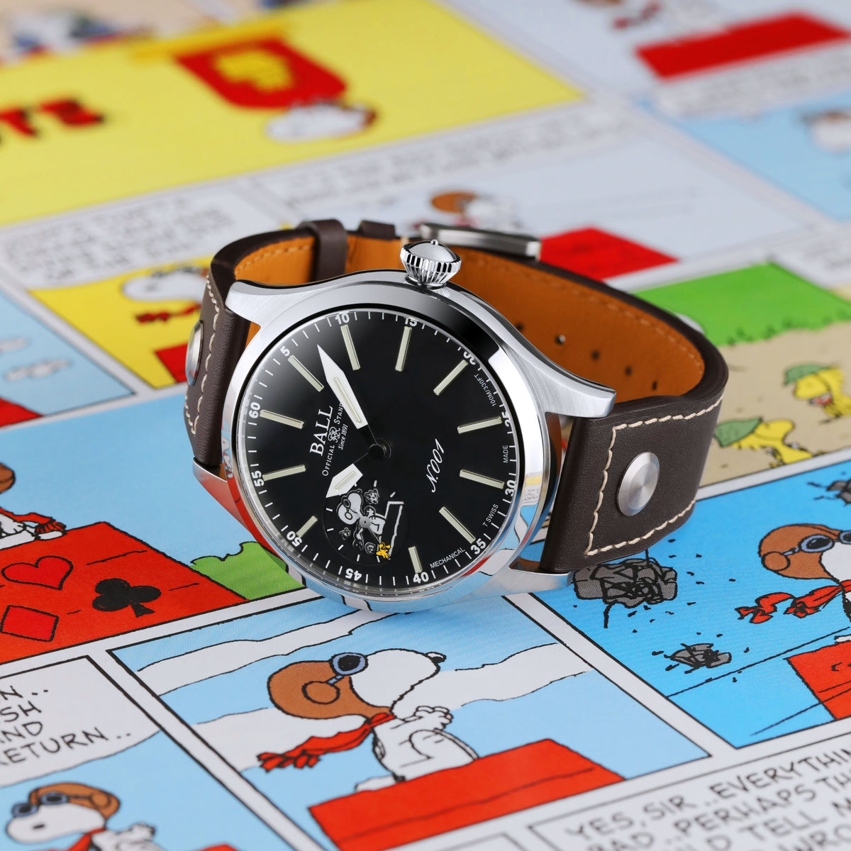 Men's manual-wind wristwatch with black dial and brown leather strap, stainless case.