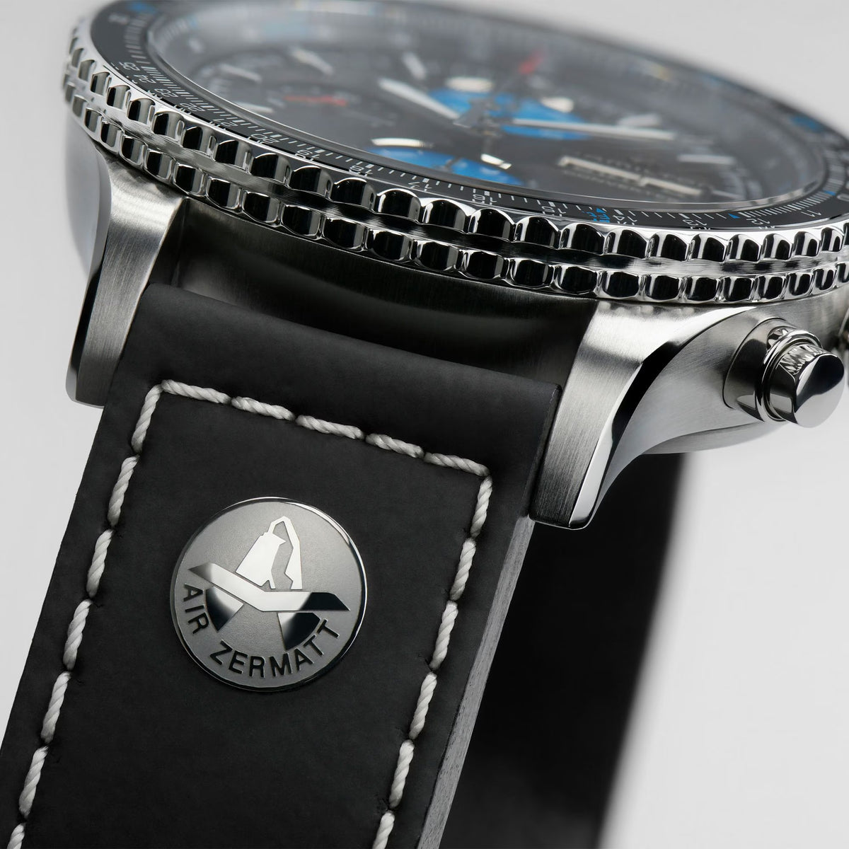 Men's automatic pilot watch side view with stainless case and black leather strap