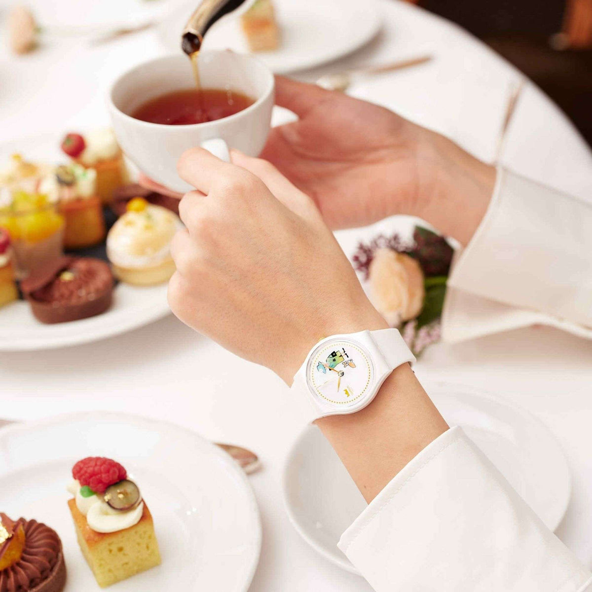 White silicone strap watch on wrist, close view of the round dial