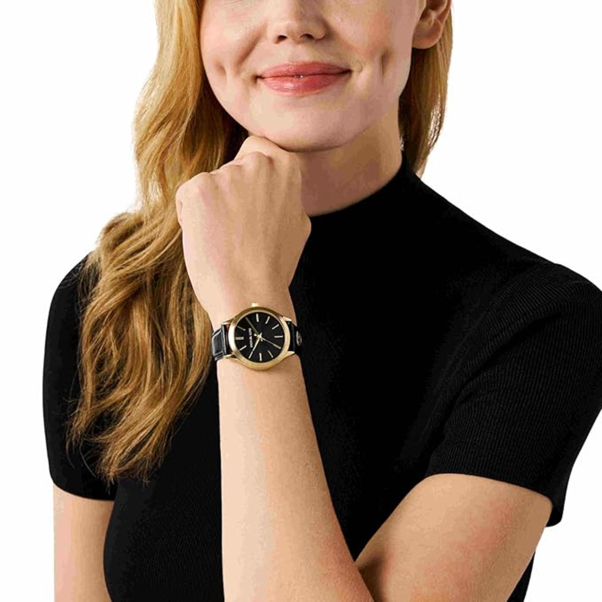Michael Kors women’s watch on wrist, featuring a black dial and black leather strap