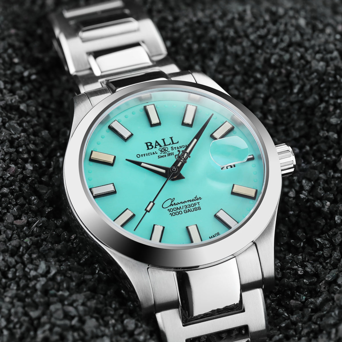 Silver steel bracelet watch with turquoise dial, baton hour markers, black hands