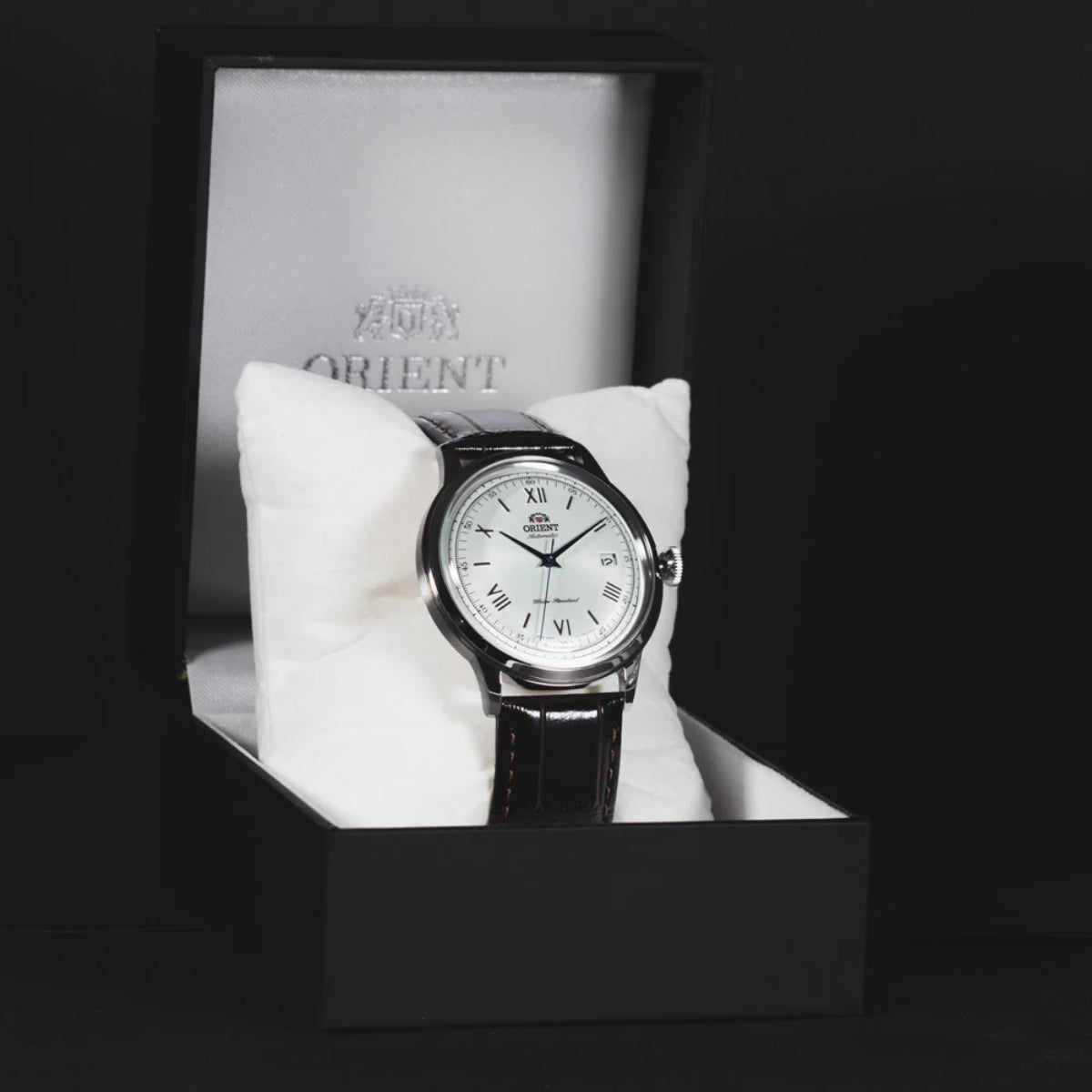 Orient Bambino TAC00009W0 automatic men's watch resting inside a black presentation box on a white cushion