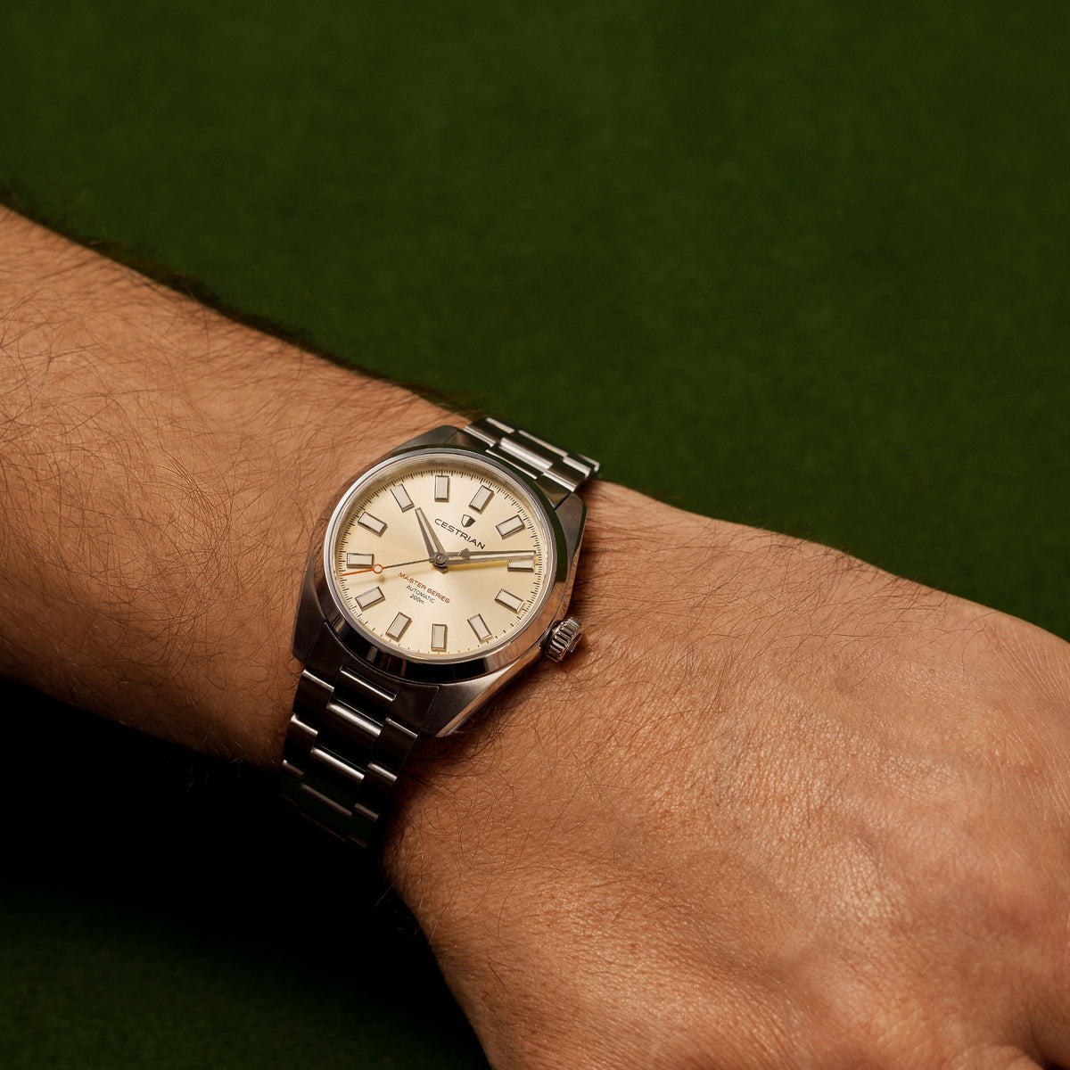 Men's steel watch on wrist with champagne dial and white minute track