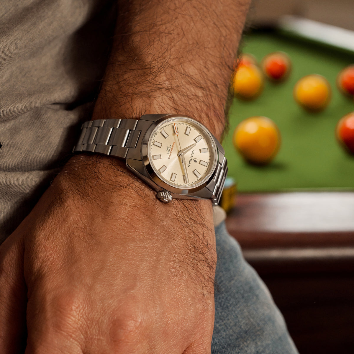 Men's automatic watch on wrist, champagne dial with subsecond and steel bracelet
