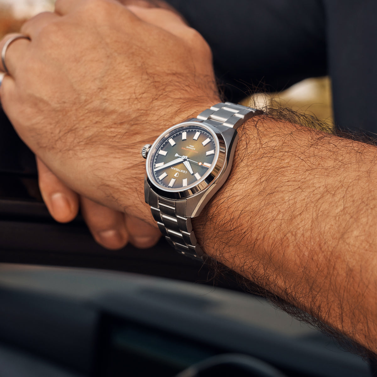 Men's automatic steel wristwatch with green dial and three-hand markers