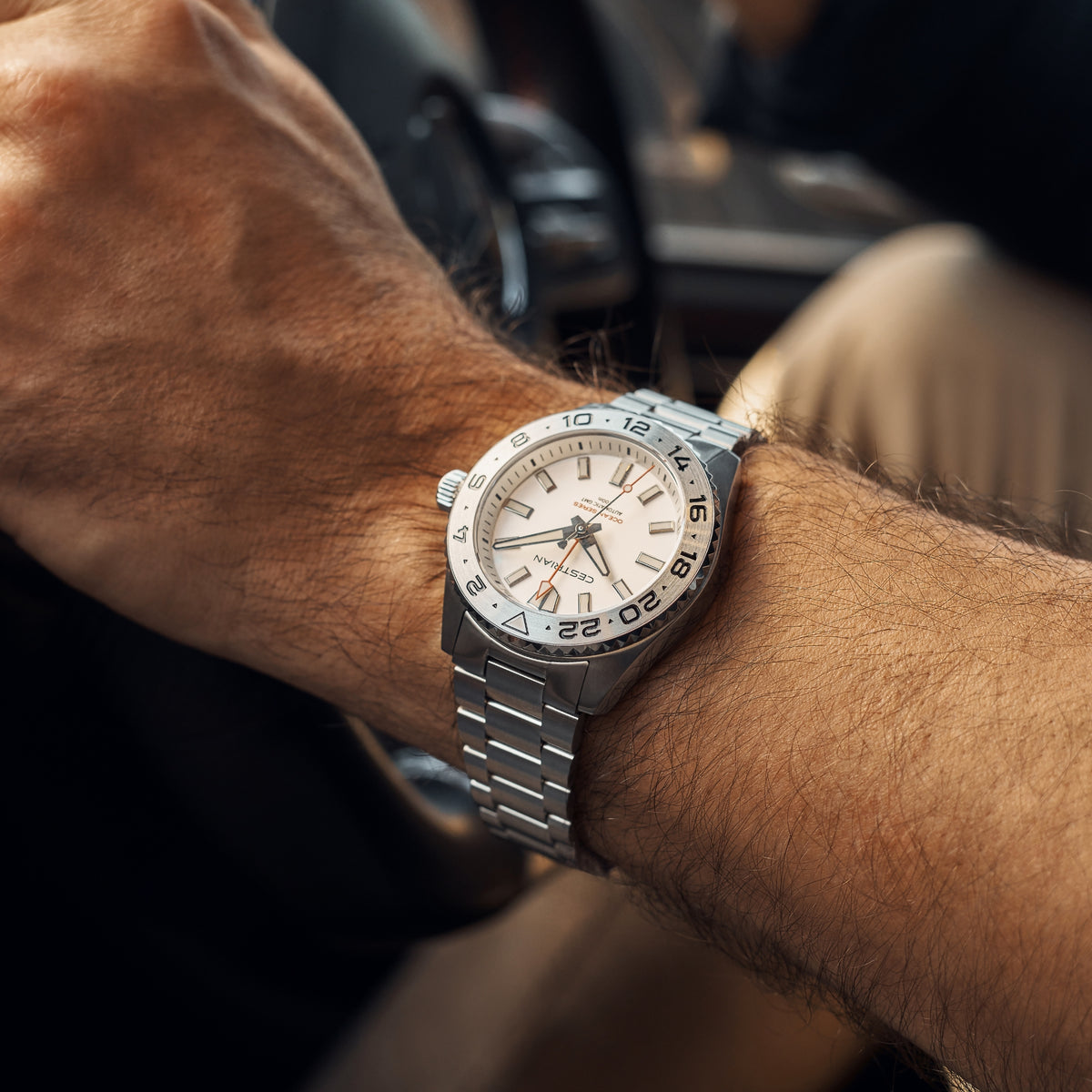 Men's silver-tone watch with white dial and stainless-steel bracelet, worn on wrist