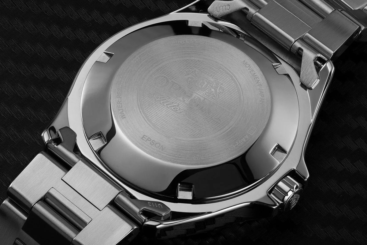 Stainless steel watch caseback with engraved details and bracelet links
