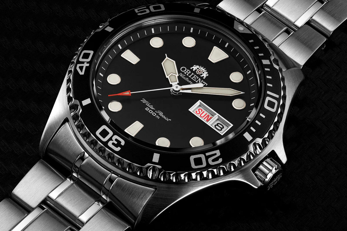 Close-up stainless steel automatic watch with black dial and date window