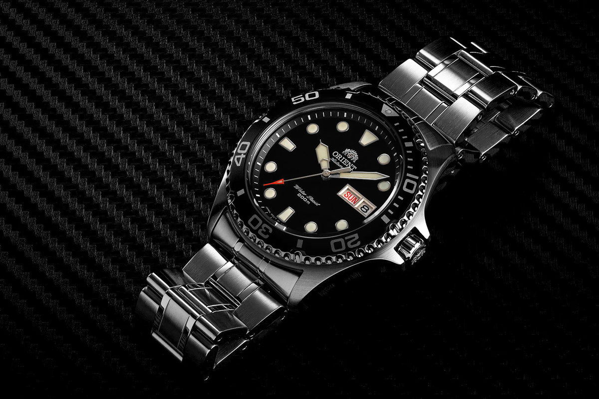 Stainless steel automatic watch with black dial, lume markers and metal bracelet