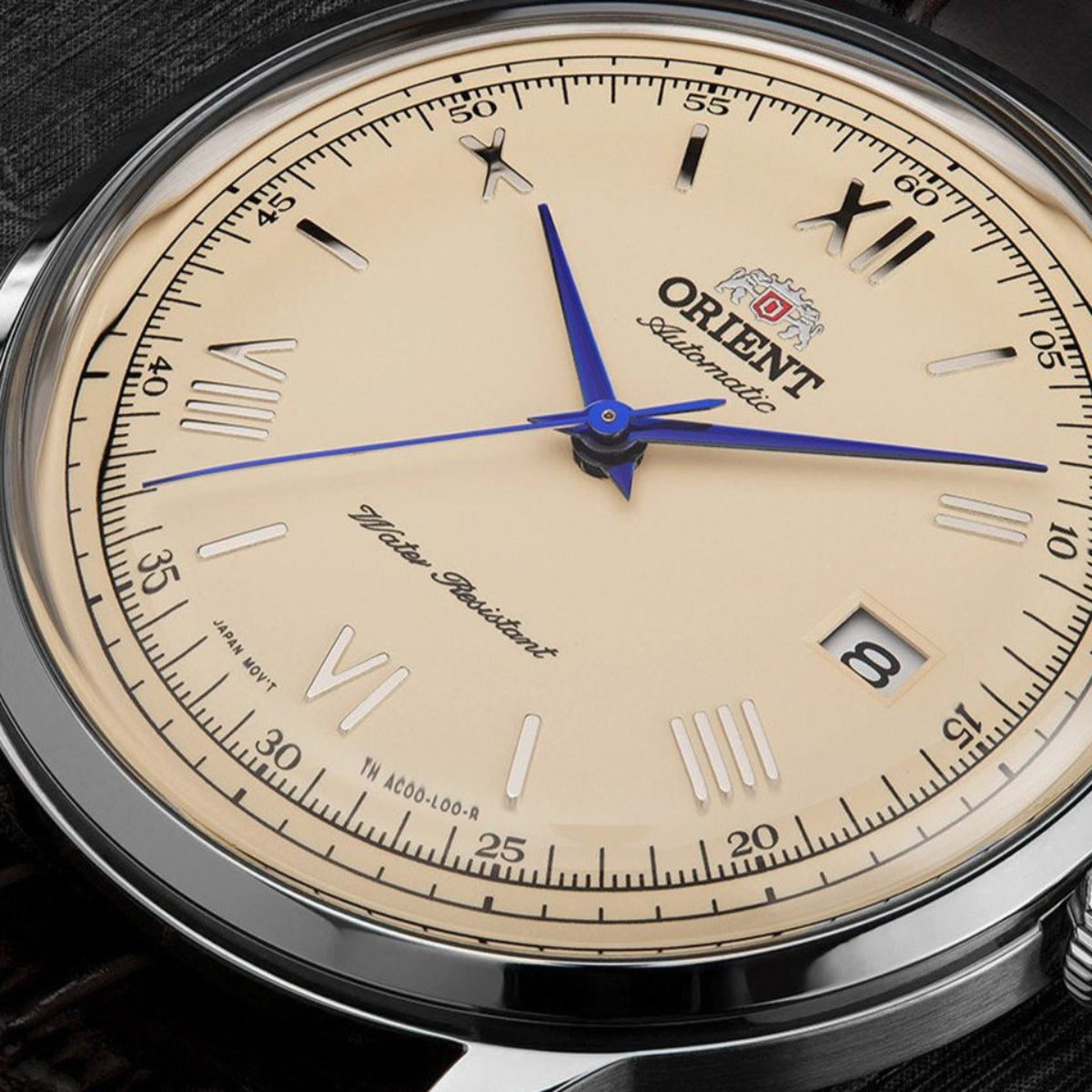Orient Bambino TAC00009N0 watch with champagne dial and blue hands on a black background