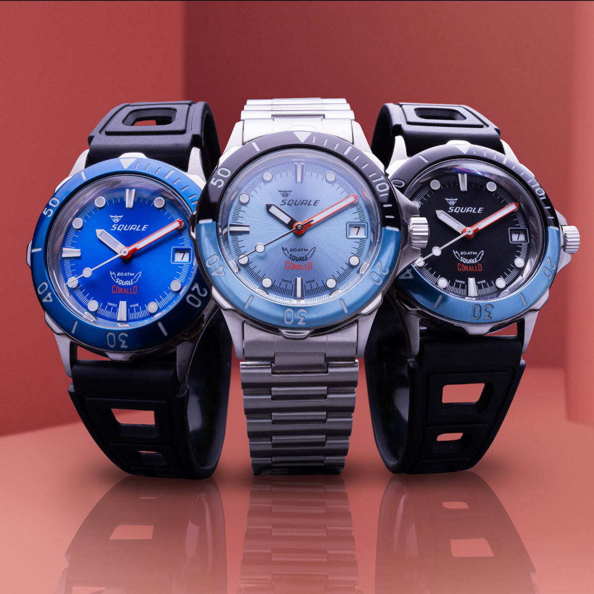 Three Squale Corallo 20 ATM automatic watches with blue, ice blue, and black dials on red backdrop