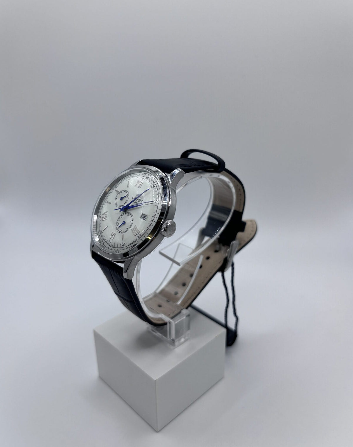 Men's automatic leather watch angled view with black strap and silver-tone case