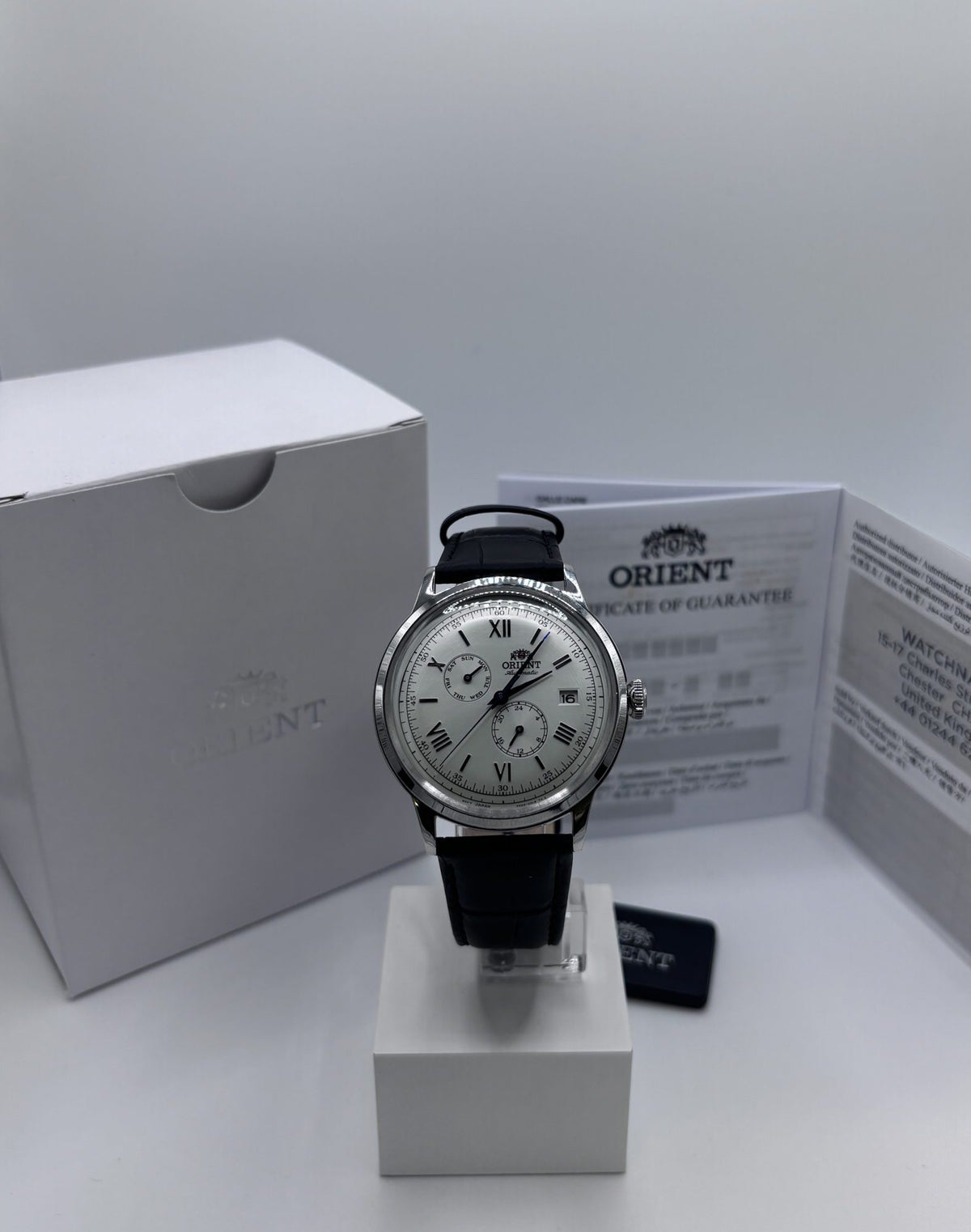 Men's automatic leather watch with white dial, black strap, and silver-tone case