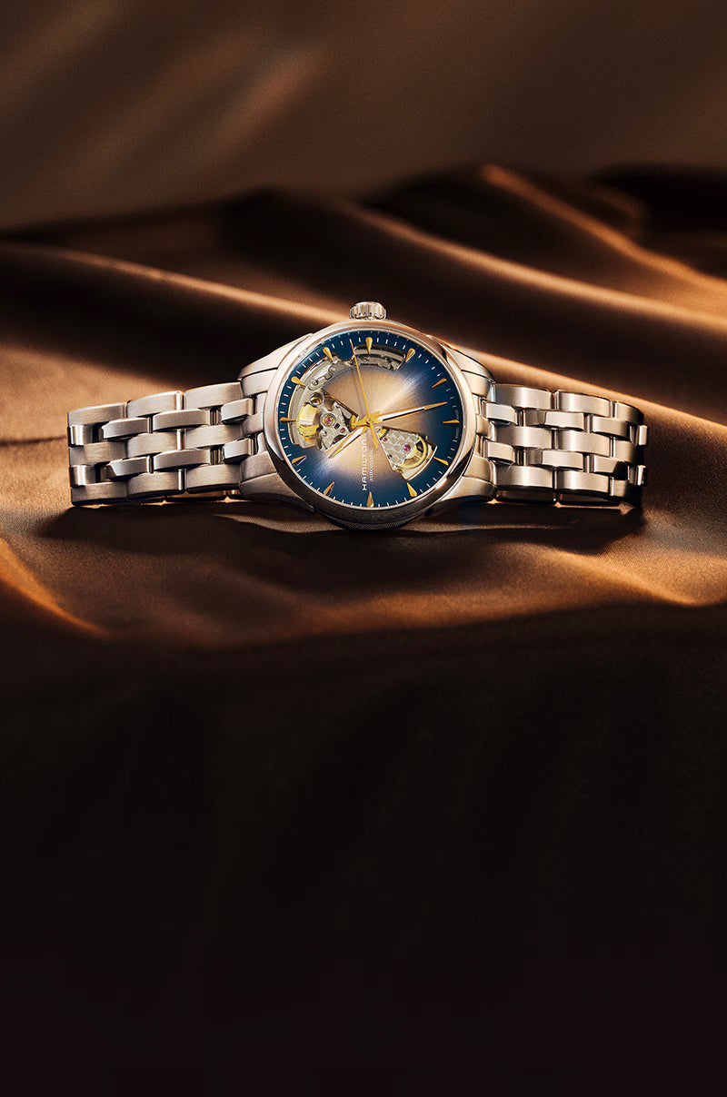 Hamilton Jazzmaster Open Heart Automatic watch featuring a blue sunray dial and stainless steel bracelet on satin