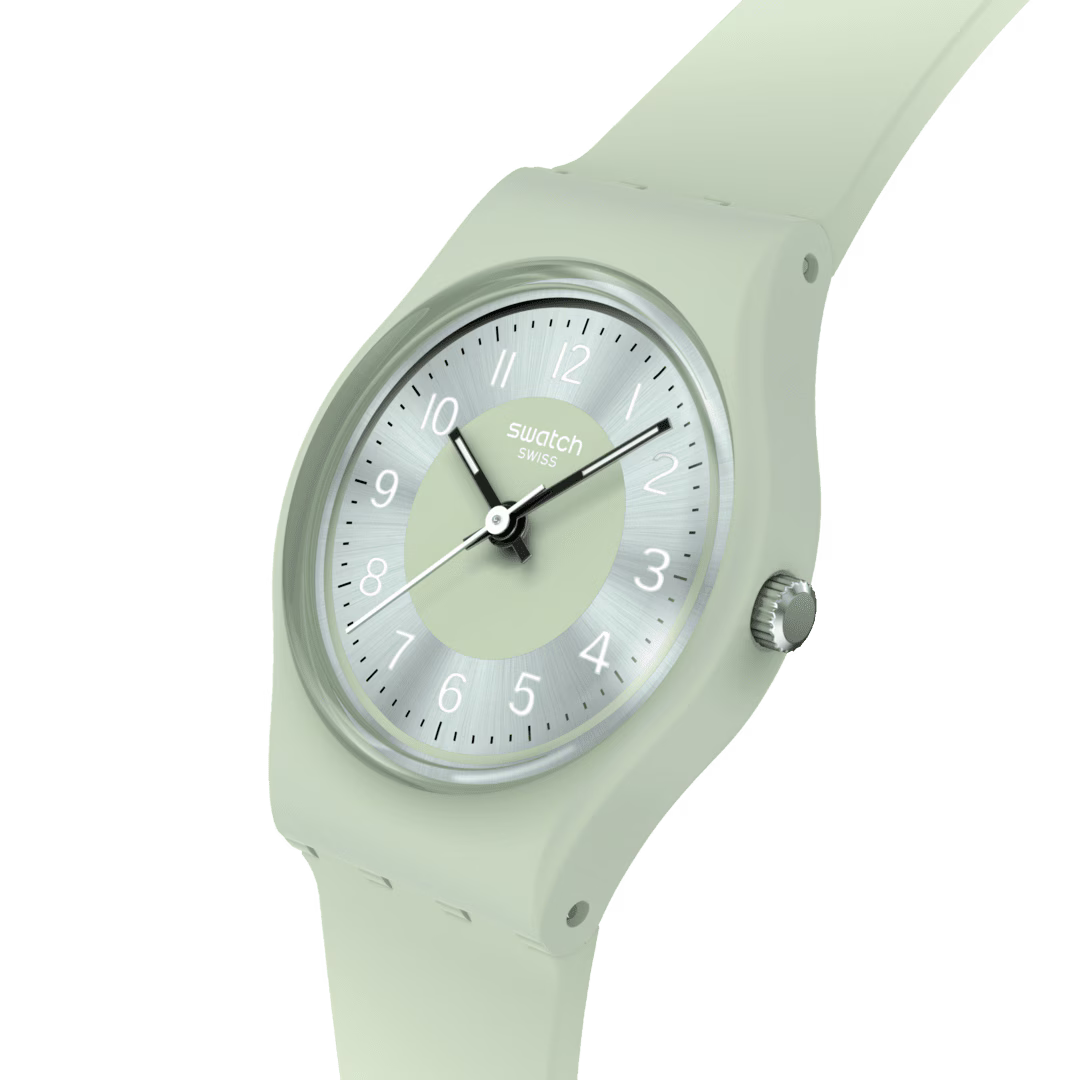 Swatch sage green silicone strap watch close-up of round dial and crown