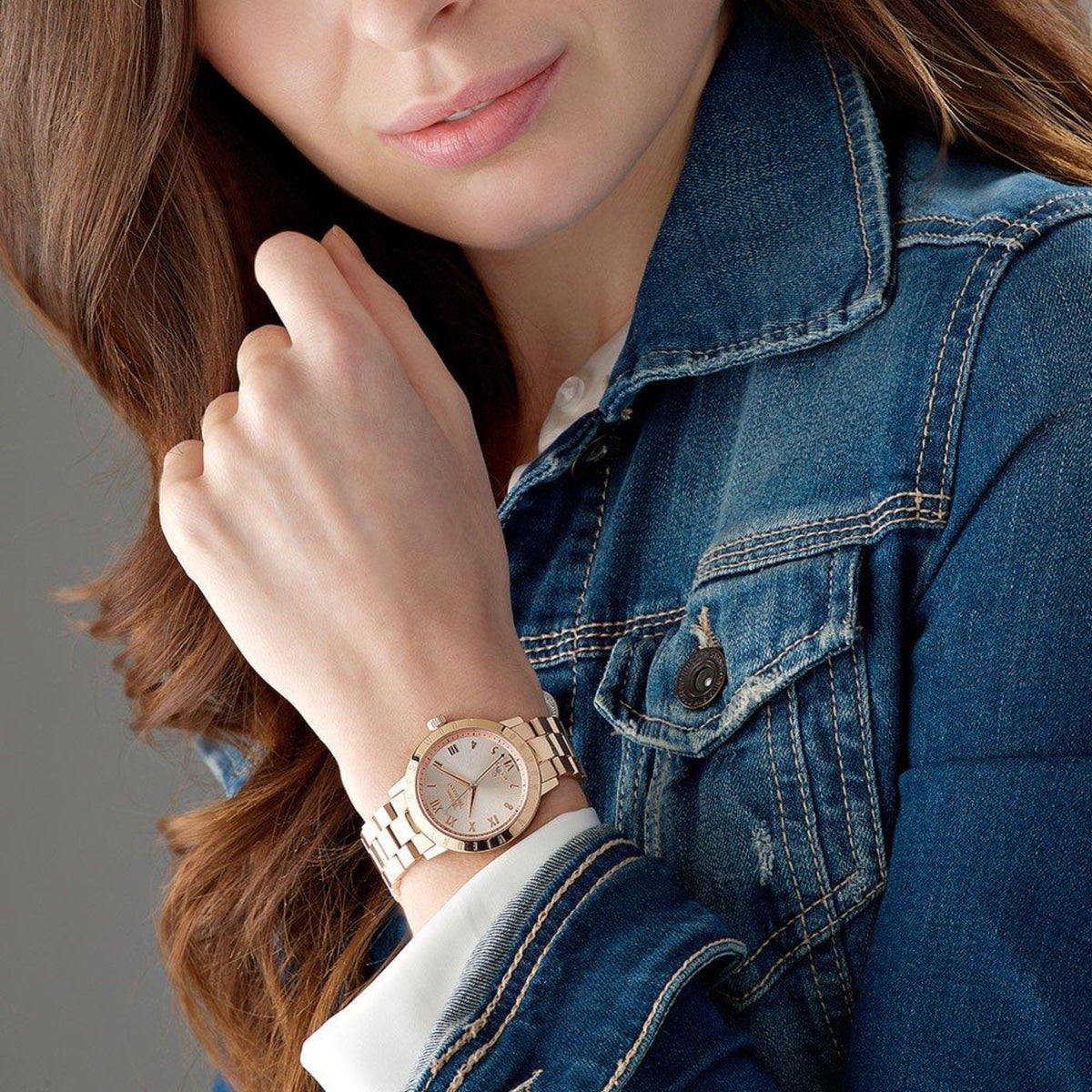 Rose gold women's wristwatch on wrist, steel bracelet and cream dial visible